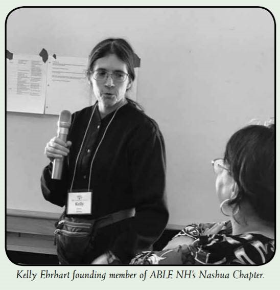 Woman holding a microphone. Kelly Ehrhart founding member of ABLE NH's Nashua Chapter